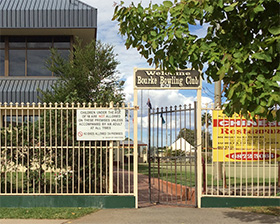 Bowling club and Chinese restaurant signs at park entrance